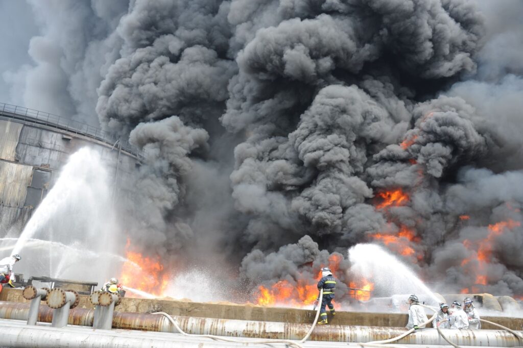 Firefighting teams in China contain the tank fire from different sides