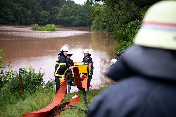 Firemen carrying lightweight Hytrans FloodPumps to nearby reservoir